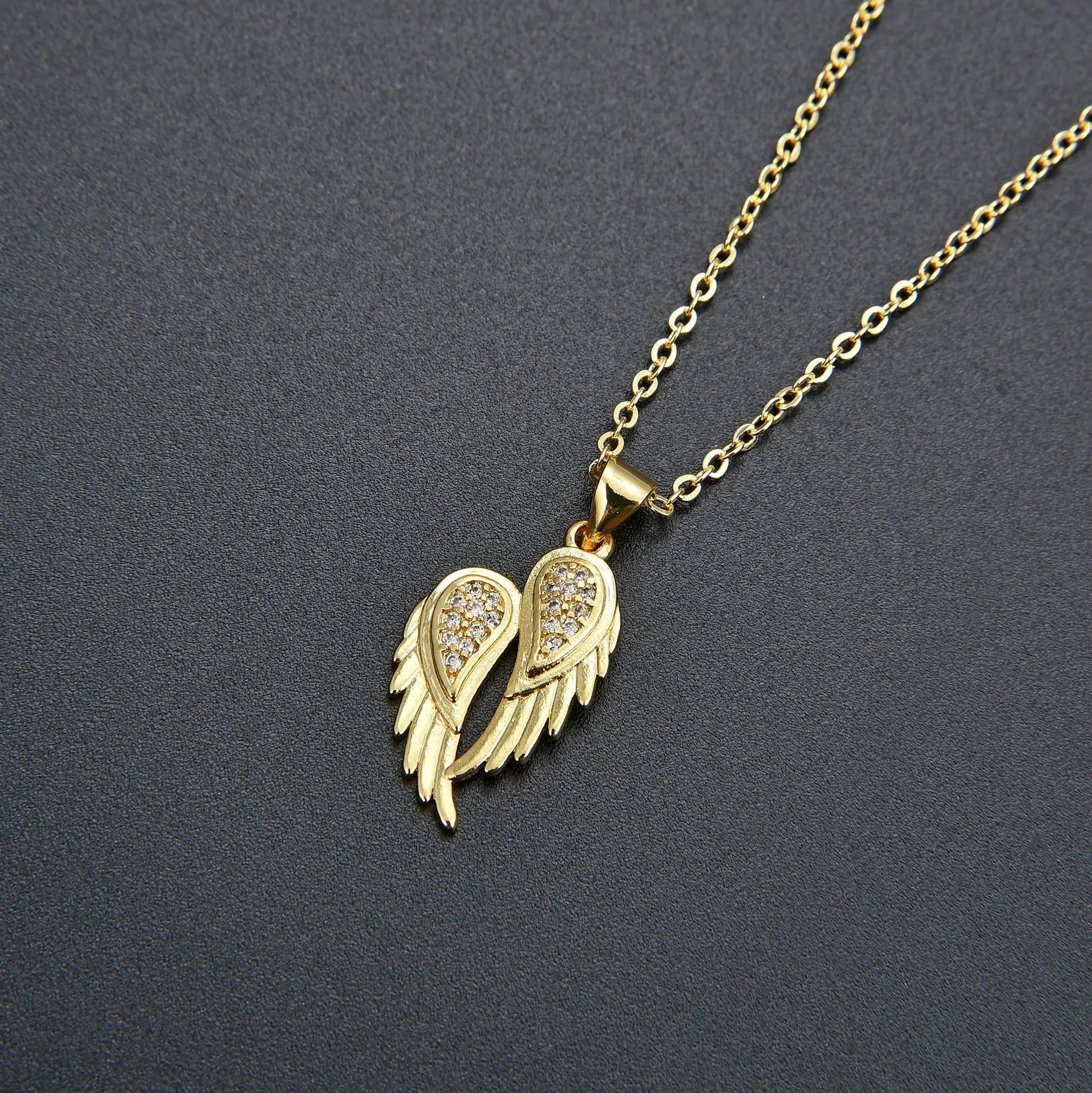 Winged Zircon Pendant Necklace in gold and silver featuring angel wing design with sparkling zircon stones, perfect for women’s elegant jewelry.