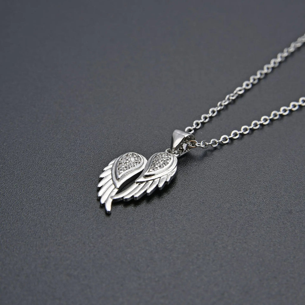 Winged Zircon Pendant Necklace in gold and silver featuring angel wing design with sparkling zircon stones, perfect for women’s elegant jewelry.