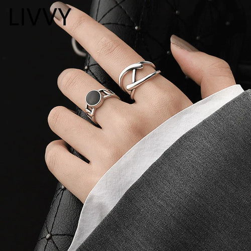 Adjustable Double Line Ring with minimalist open band design worn on woman's hand. Elegant silver tone ideal for chic everyday or party wear.