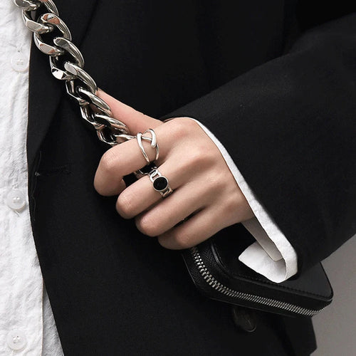 Adjustable Double Line Ring with minimalist open band design worn on woman's hand. Elegant silver tone ideal for chic everyday or party wear.