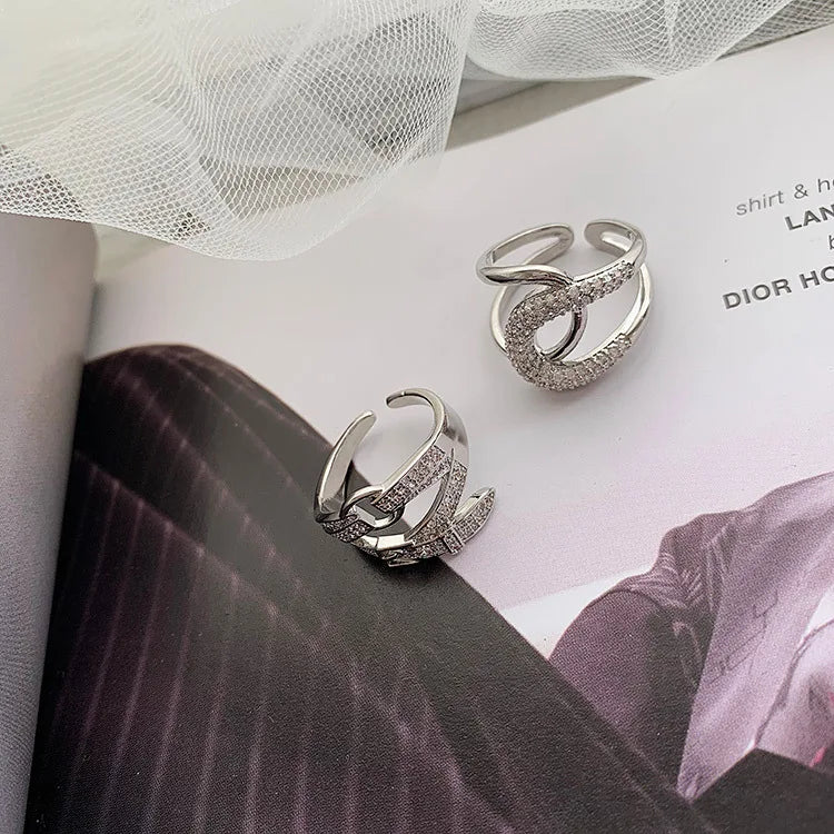 Curved diamond contour wedding band in elegant silver finish, shown on hand with blue matte nails. Stylish gold and white gold ring for special occasions.