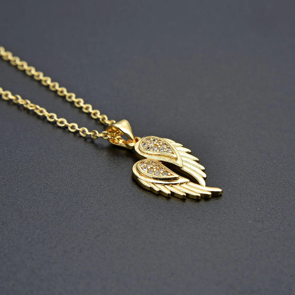 Winged Zircon Pendant Necklace in gold and silver featuring angel wing design with sparkling zircon stones, perfect for women’s elegant jewelry.