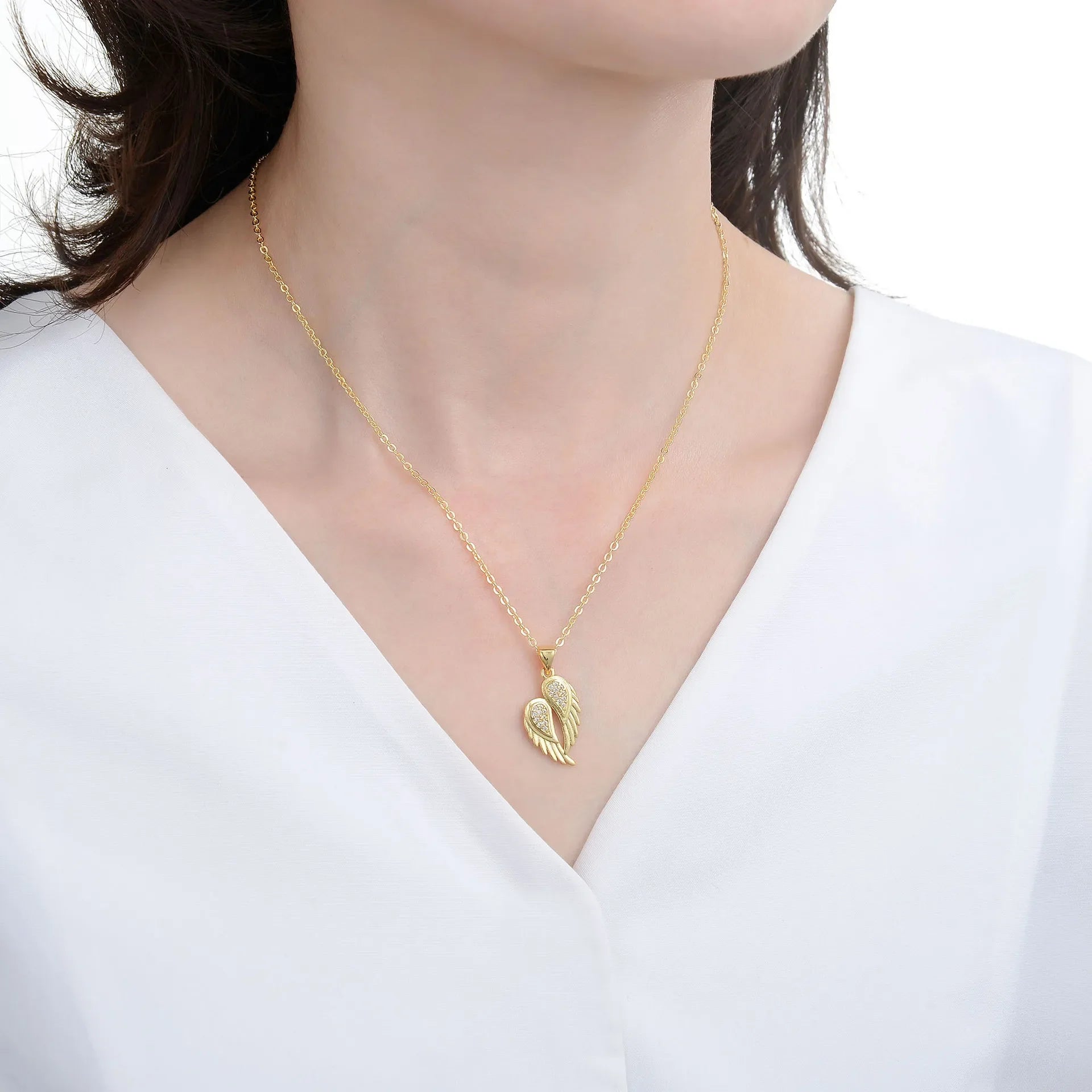Winged Zircon Pendant Necklace in gold and silver featuring angel wing design with sparkling zircon stones, perfect for women’s elegant jewelry.