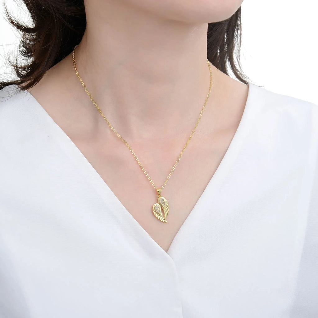 Winged Zircon Pendant Necklace in gold and silver featuring angel wing design with sparkling zircon stones, perfect for women’s elegant jewelry.