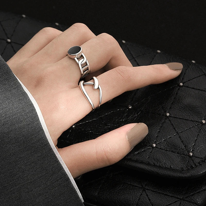 Adjustable Double Line Ring with minimalist open band design worn on woman's hand. Elegant silver tone ideal for chic everyday or party wear.