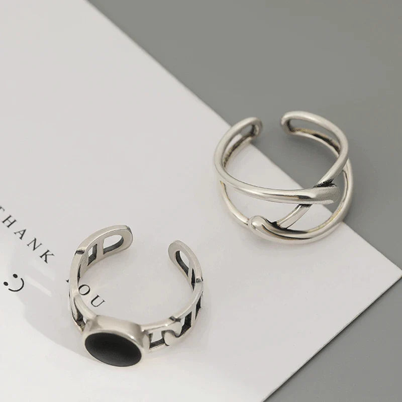 Adjustable Double Line Ring with minimalist open band design worn on woman's hand. Elegant silver tone ideal for chic everyday or party wear.