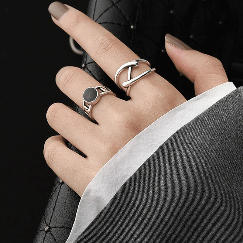 Adjustable Double Line Ring with minimalist open band design worn on woman's hand. Elegant silver tone ideal for chic everyday or party wear.