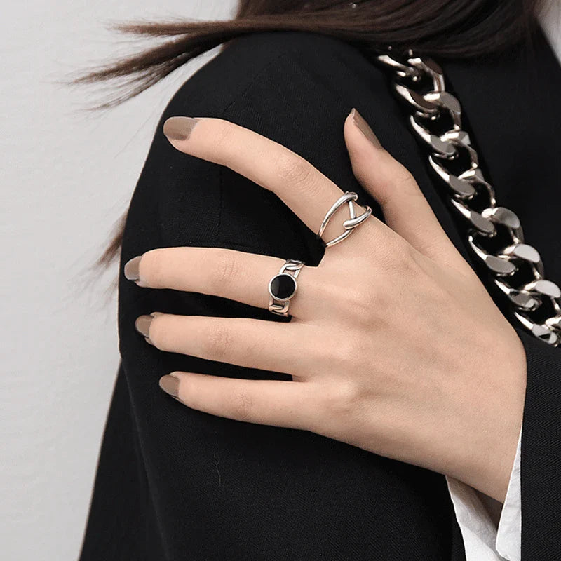 Adjustable Double Line Ring with minimalist open band design worn on woman's hand. Elegant silver tone ideal for chic everyday or party wear.