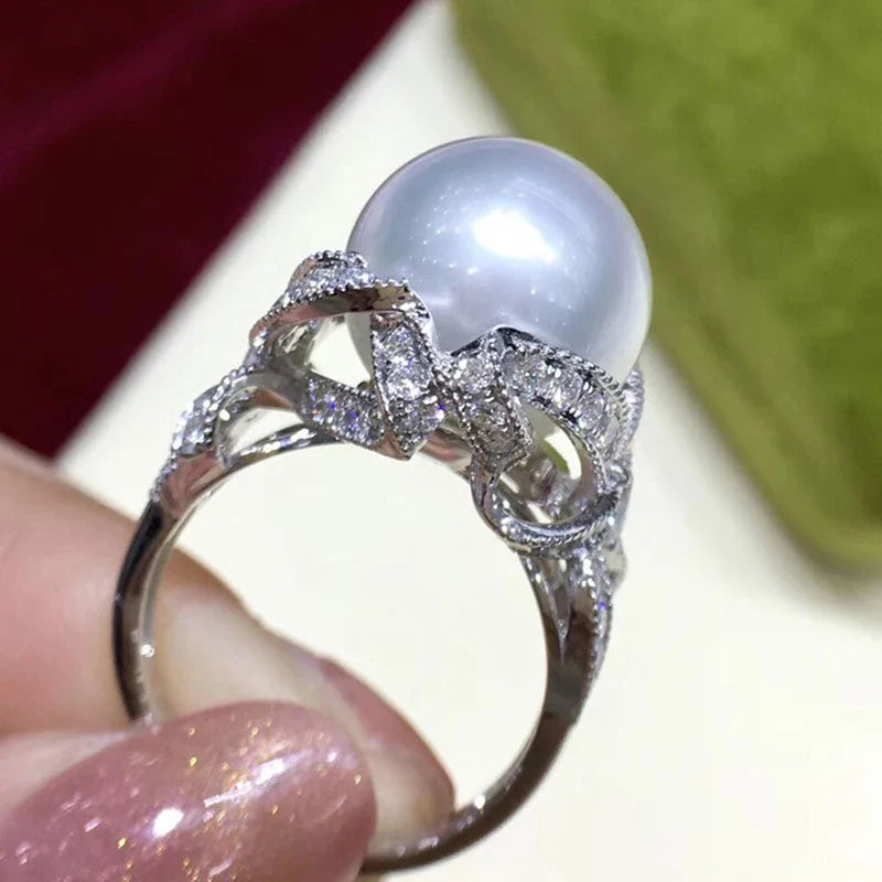 Huitan romantic bridal ring for women featuring a large pearl centerpiece and elegant twisted band with sparkling pavé stones, ideal for weddings.