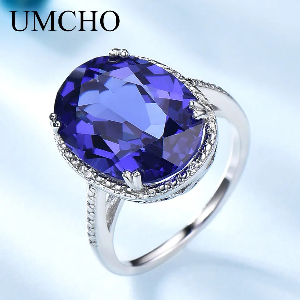 Elegant Silver Wedding Ring with round-cut Tanzanite Zircon on hand, showcasing fine jewelry craftsmanship for engagements or weddings.