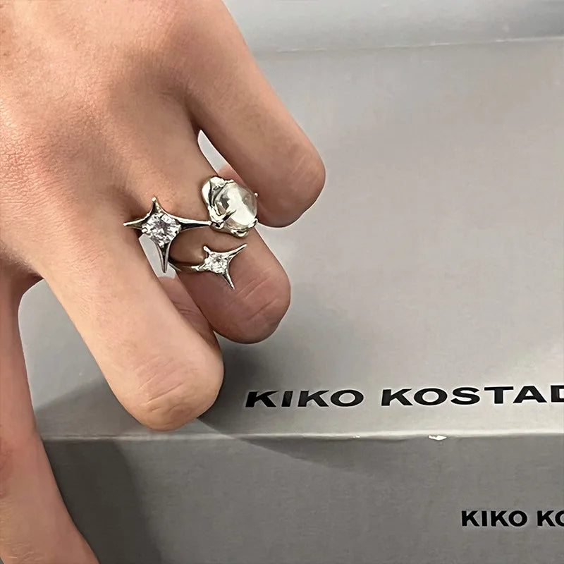 Shimmer Star Ring elegant adjustable star ring for women in silver, worn on hand with black sweater, ideal for stylish everyday jewelry.