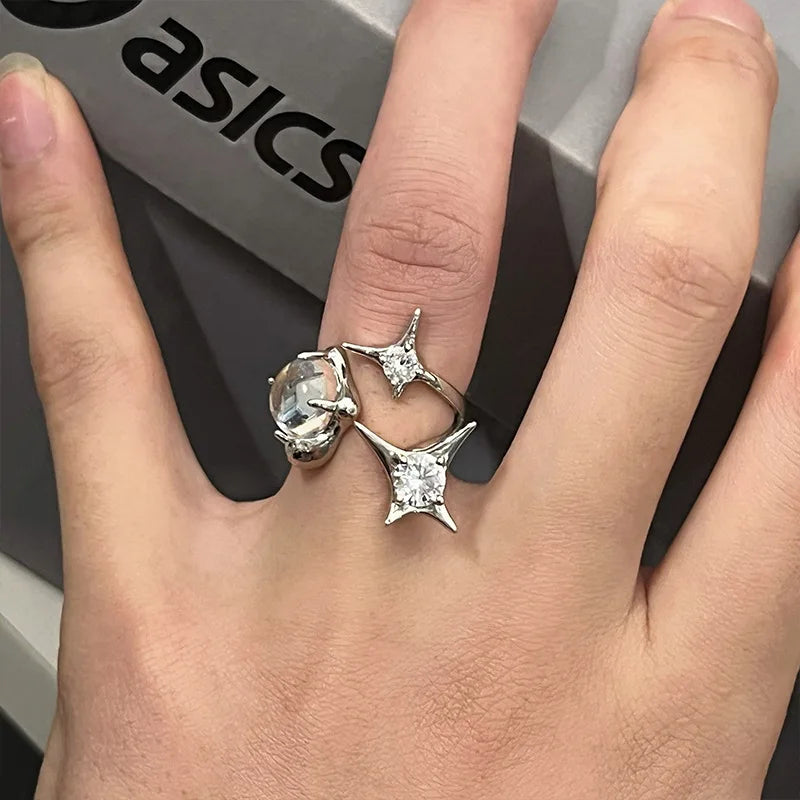 Shimmer Star Ring elegant adjustable star ring for women in silver, worn on hand with black sweater, ideal for stylish everyday jewelry.