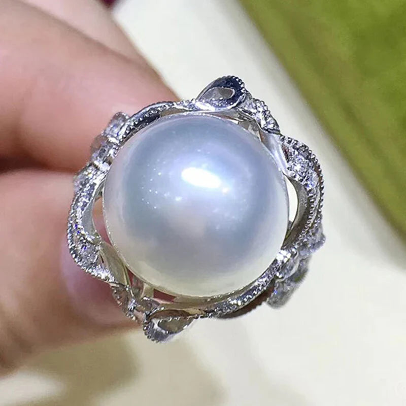 Huitan romantic bridal ring for women featuring a large pearl centerpiece and elegant twisted band with sparkling pavé stones, ideal for weddings.