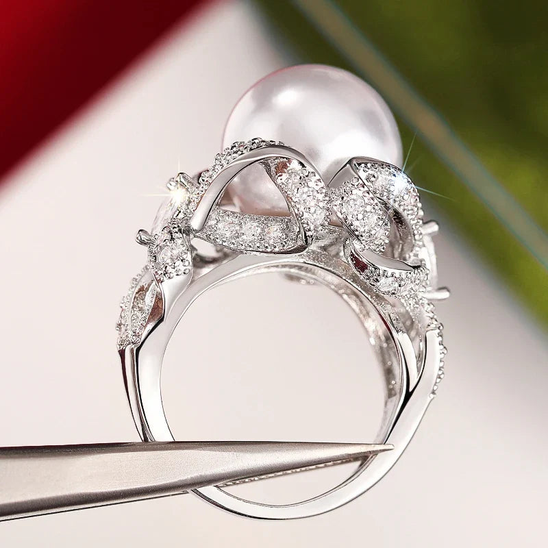 Huitan romantic bridal ring for women featuring a large pearl centerpiece and elegant twisted band with sparkling pavé stones, ideal for weddings.