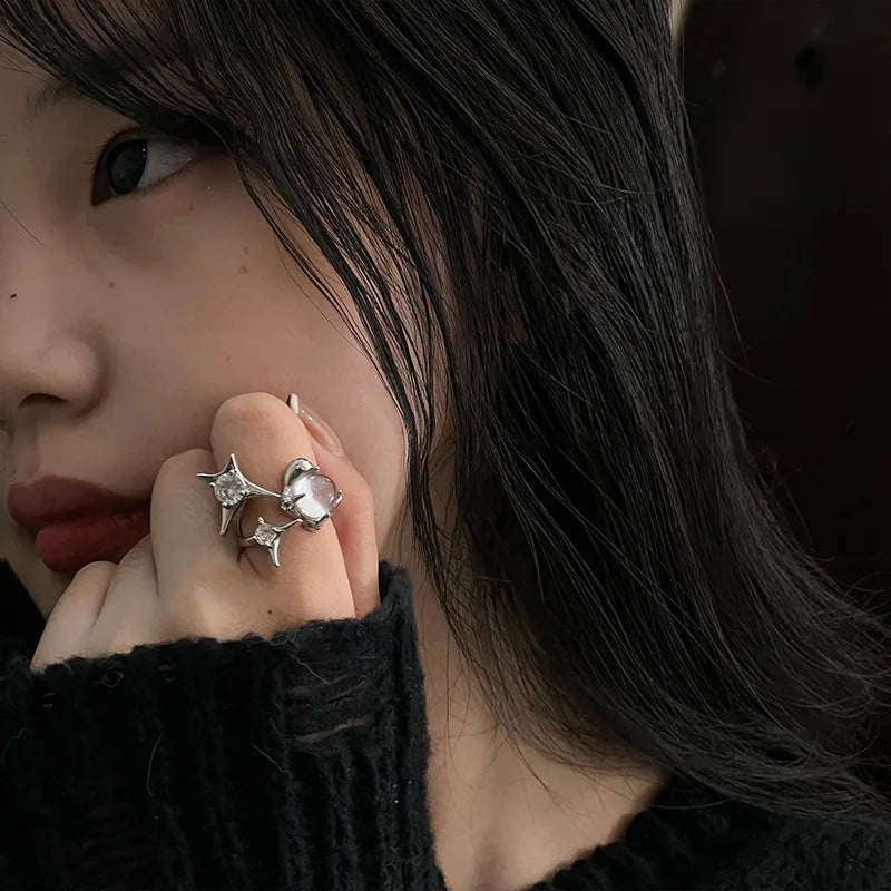 Shimmer Star Ring elegant adjustable star ring for women in silver, worn on hand with black sweater, ideal for stylish everyday jewelry.