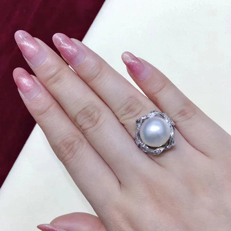 Huitan romantic bridal ring for women featuring a large pearl centerpiece and elegant twisted band with sparkling pavé stones, ideal for weddings.